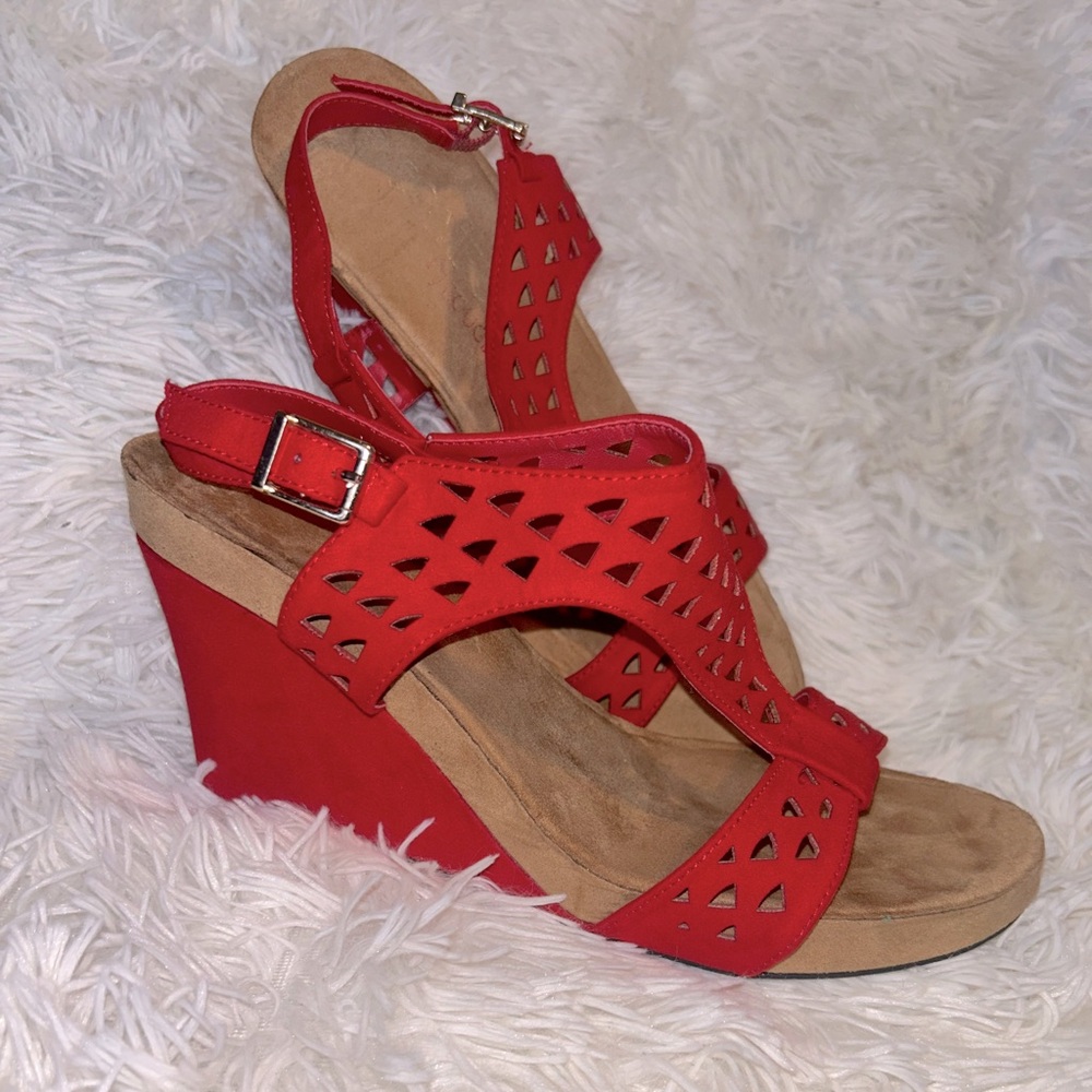 Red faux suede wedge heel sandal with a silver buckle.